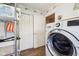 Well-organized laundry area with modern LG washer, storage shelves, and stylish accents, offering convenience and functionality at 715 Stockbridge Dr, Westfield, IN 46074
