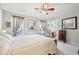Inviting main bedroom with a ceiling fan, a sitting area, and an en-suite bathroom at 715 Stockbridge Dr, Westfield, IN 46074