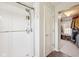 A close up view of the shower with tiled walls and glass door, next to the closet at 715 Stockbridge Dr, Westfield, IN 46074