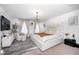 Elegant bedroom with stylish lighting fixture, a large modern bed, striped rug, and natural light at 7239 Governors Row, Avon, IN 46123