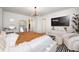 Bedroom with a modern bed, stylish lighting, sleek dresser, decorative chair, and a large mirror at 7239 Governors Row, Avon, IN 46123