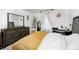 Serene bedroom featuring a cozy bed, wooden furniture, stylish mirror, and soft, natural light at 7239 Governors Row, Avon, IN 46123