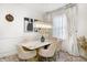 Elegant dining room featuring a marble table, plush chairs, stylish lighting, and sheer window coverings at 7239 Governors Row, Avon, IN 46123