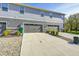 Modern townhome showcasing a private driveway and attached two-car garage at 7239 Governors Row, Avon, IN 46123