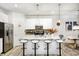 Modern kitchen with a large island, seating, stainless steel appliances, and an open concept design at 7239 Governors Row, Avon, IN 46123