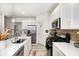 Bright kitchen with stainless steel appliances, a large sink, and sleek countertops at 7239 Governors Row, Avon, IN 46123