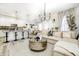 Open-concept living area with modern decor, a dining area, and a breakfast bar at 7239 Governors Row, Avon, IN 46123