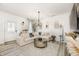 Bright living room featuring an elegant chandelier, cozy seating, and stylish decor at 7239 Governors Row, Avon, IN 46123