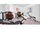 Bright home office area featuring work-out equipment, a large mirror, and a work-station with a monitor and office chair at 7239 Governors Row, Avon, IN 46123