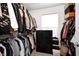 Organized walk-in closet with an abundance of hanging space, shelving, and a bright window at 7239 Governors Row, Avon, IN 46123
