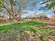 Expansive backyard with mature trees, large grassy area, and a brick home with a screened porch at 7671 Sherry Ln, Brownsburg, IN 46112