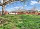A spacious backyard with a large grassy area, perfect for outdoor activities, in front of a red brick home at 7671 Sherry Ln, Brownsburg, IN 46112