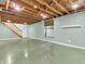 Unfinished basement space with exposed ceiling, painted concrete floor, and access to stairs at 7671 Sherry Ln, Brownsburg, IN 46112