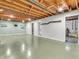 Unfinished basement area featuring exposed wood beams, painted concrete floor, and ample open space at 7671 Sherry Ln, Brownsburg, IN 46112