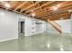 Unfinished basement featuring open ceiling, painted concrete floor, stairs, and doorway at 7671 Sherry Ln, Brownsburg, IN 46112