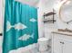 Bright bathroom with fish-themed shower curtain, vanity with granite counters, and tile floors at 7671 Sherry Ln, Brownsburg, IN 46112