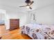 This cozy bedroom features hardwood floors, a wooden dresser and a large bed at 7671 Sherry Ln, Brownsburg, IN 46112
