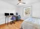 Bedroom with hardwood floors, ceiling fan, desk, and window that provides bright natural lighting at 7671 Sherry Ln, Brownsburg, IN 46112
