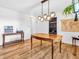 A stylish dining room boasts a modern light fixture and a wooden table with vintage accents at 7671 Sherry Ln, Brownsburg, IN 46112