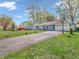 The front of this home features a long driveway, two-car garage, and a well-maintained lawn with mature trees at 7671 Sherry Ln, Brownsburg, IN 46112
