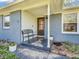 Inviting front porch with a charming black bench, potted plants, and a decorative front door enhances curb appeal at 7671 Sherry Ln, Brownsburg, IN 46112