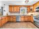 This kitchen boasts stainless steel appliances, ample counter space, and custom light brown cabinetry at 7671 Sherry Ln, Brownsburg, IN 46112