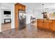 Kitchen leading to dining space, showing a large refrigerator and an island with a stone counter at 7671 Sherry Ln, Brownsburg, IN 46112
