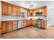 A well-equipped kitchen features stainless steel appliances and light brown custom cabinetry at 7671 Sherry Ln, Brownsburg, IN 46112