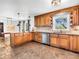 A spacious kitchen features a central island, stainless appliances and custom light brown cabinetry at 7671 Sherry Ln, Brownsburg, IN 46112