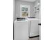 A practical laundry room features a washer, a dryer, shelves and a window at 7671 Sherry Ln, Brownsburg, IN 46112
