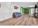 Open-concept living room featuring beautiful hardwood floors, natural lighting, and modern light fixtures at 7671 Sherry Ln, Brownsburg, IN 46112