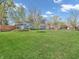 Landscaped side yard featuring a well-maintained lawn and decorative fencing creates a welcoming outdoor space at 7671 Sherry Ln, Brownsburg, IN 46112