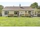 Well-manicured backyard with lush green lawn, a cozy deck and an inviting back exterior at 768 Grace Ct, Carmel, IN 46032