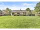 Beautifully maintained backyard with lush green grass leading to a well-kept home and deck at 768 Grace Ct, Carmel, IN 46032