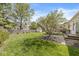 Landscaped backyard featuring a large grassy area, mature trees, and a wooden fence at 768 Grace Ct, Carmel, IN 46032