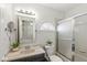 Bright bathroom featuring an extended vanity countertop and a shower/tub combo with glass doors at 768 Grace Ct, Carmel, IN 46032