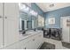 Bathroom with double sink vanity, modern fixtures, and an adjacent laundry area at 768 Grace Ct, Carmel, IN 46032