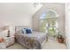 Bedroom features a vaulted ceiling, an arched window, and cozy décor at 768 Grace Ct, Carmel, IN 46032