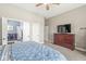 Bedroom featuring a dresser with a TV, ceiling fan, and an ensuite laundry room at 768 Grace Ct, Carmel, IN 46032