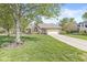 Attractive brick home with a manicured lawn, mature tree, and spacious driveway at 768 Grace Ct, Carmel, IN 46032