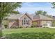 Charming brick home featuring a manicured lawn, mature landscaping, and an attached two-car garage at 768 Grace Ct, Carmel, IN 46032