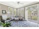 Bright sunroom features a comfortable seating area, large windows, and access to the deck at 768 Grace Ct, Carmel, IN 46032