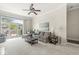 Bright living room featuring a ceiling fan, neutral carpet, and sliding glass doors leading to an outdoor patio at 768 Grace Ct, Carmel, IN 46032