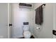 Cozy bathroom with a white toilet and dark-toned hardwood flooring at 7756 N Audubon Rd, Indianapolis, IN 46250