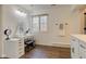 Bright bathroom featuring a vanity, window, and dark-toned hardwood flooring at 7756 N Audubon Rd, Indianapolis, IN 46250