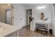 Bright bathroom featuring a vanity, window, and dark-toned hardwood flooring at 7756 N Audubon Rd, Indianapolis, IN 46250