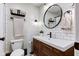 Stylish bathroom featuring a wood vanity, modern fixtures, and subway tile creating a clean aesthetic at 7756 N Audubon Rd, Indianapolis, IN 46250