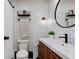 Stylish bathroom with modern fixtures, a round mirror, and white subway tile at 7756 N Audubon Rd, Indianapolis, IN 46250