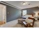 Comfortable bedroom with a cozy chair, end tables, and soothing dark paint at 7756 N Audubon Rd, Indianapolis, IN 46250