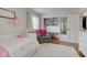 Bright bedroom featuring a daybed, comfortable armchair, and a well-organized closet with built-in storage at 7756 N Audubon Rd, Indianapolis, IN 46250